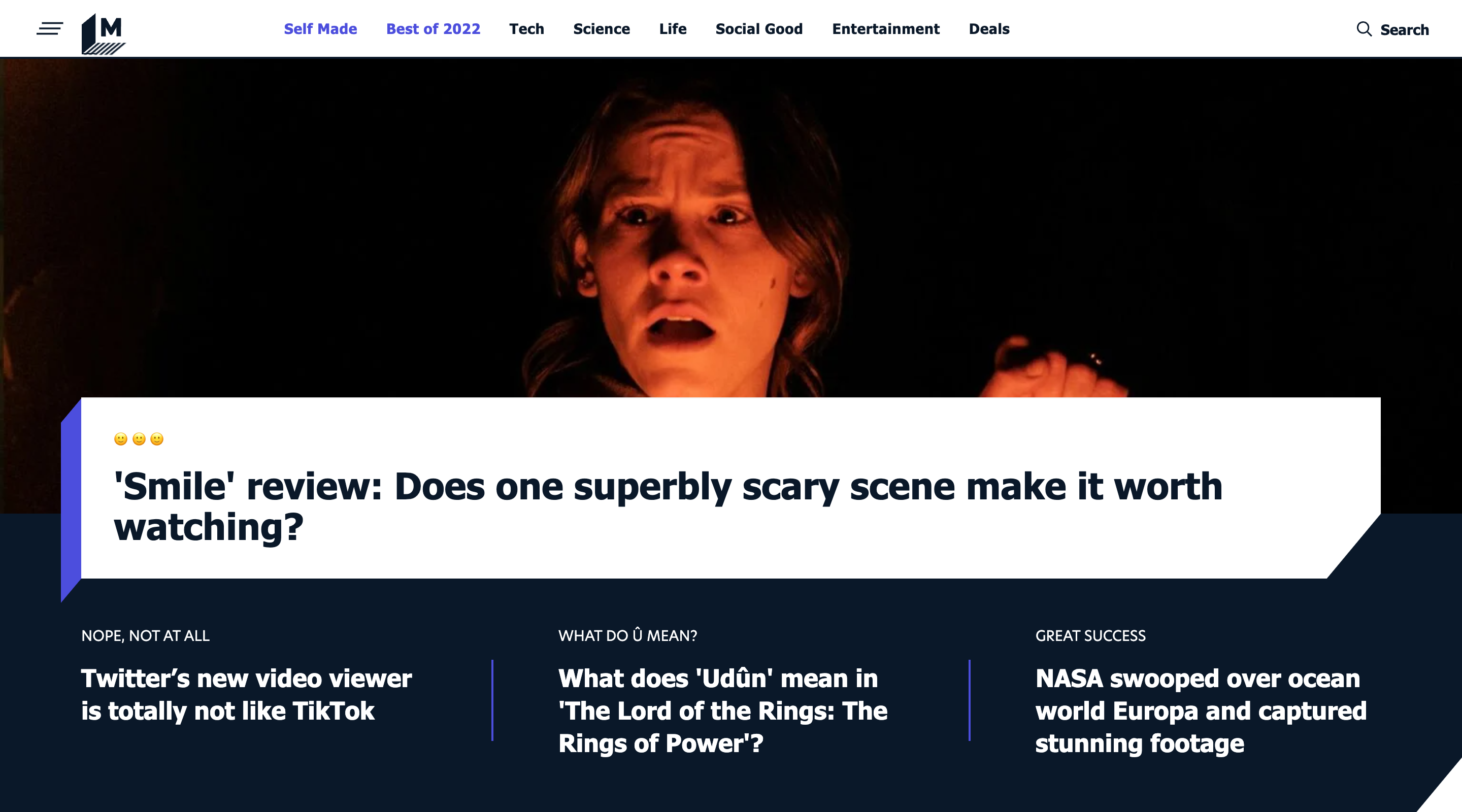 Screenshot of the Mashable home page. The header contains a menu button, the Mashable logo, the main site navigation, and a search button. The hero section contains a featured article with a large background image and heading. Three additional article titles are displayed in a row underneath.