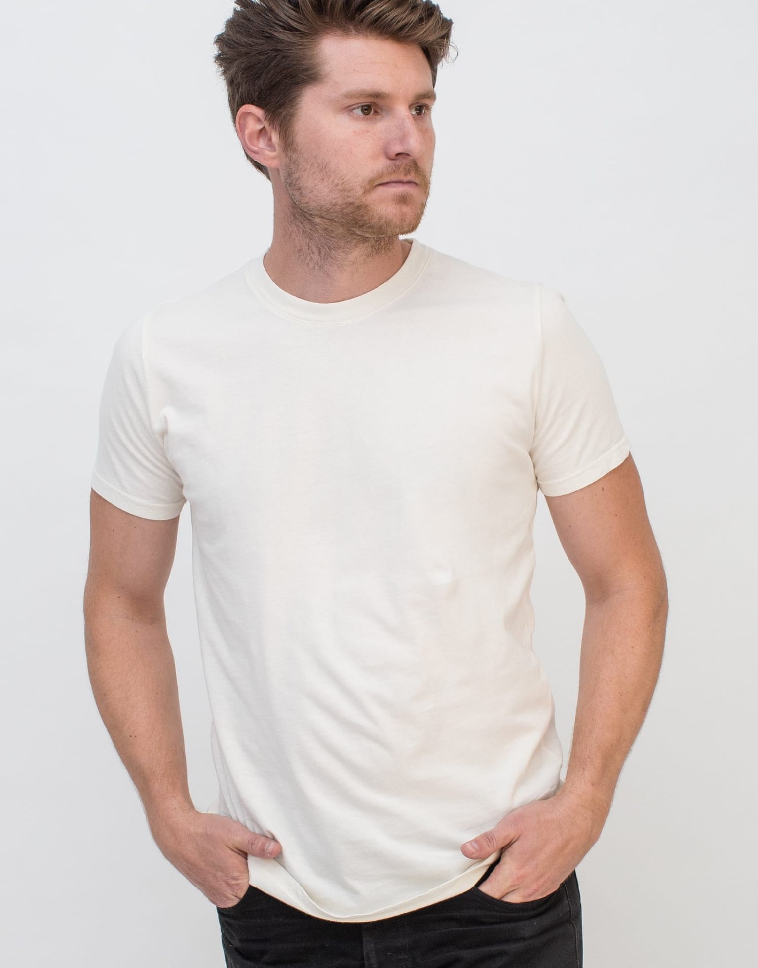 Model wearing plain white basic tee.