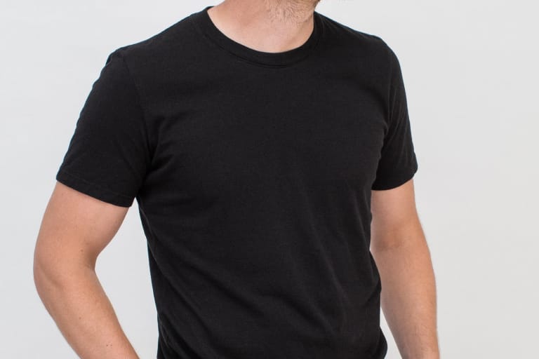 Model wearing plain black basic tee.